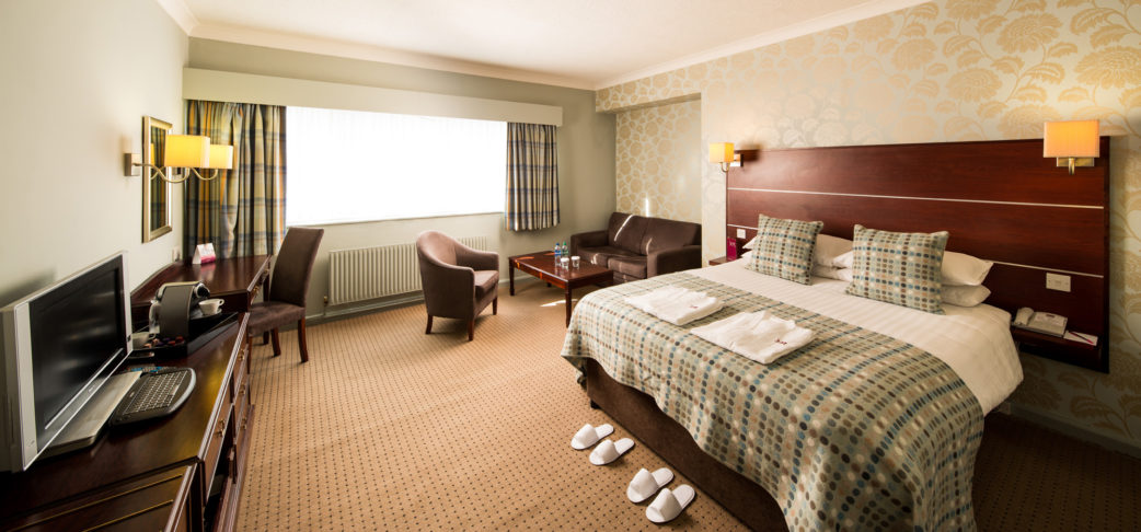 mercure-hotels-jh-bedroom-privilege-room_002l-120514 Angled view of Double bed, desk, HDTV, slippers and dressing gowns in a Privilege Room at Mercure Hotels