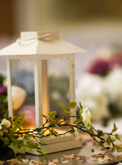 Wedding breakfast table centrepiece close up, candle, flowers