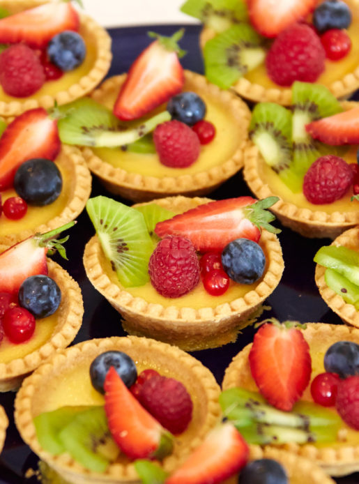 Tray of fruit deserts being served at a wedding or event