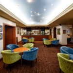 The bar and lounge area at Mercure Norwich Hotel, blue and green armchairs