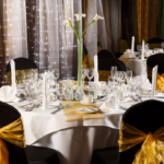 The City Suite at Mercure Norwich Hotel, set up for a wedding breakfast, black linen with yellow sashes