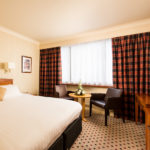 Classic double bedroom at Mercure Norwich Hotel, double bed, side table and desk with TV