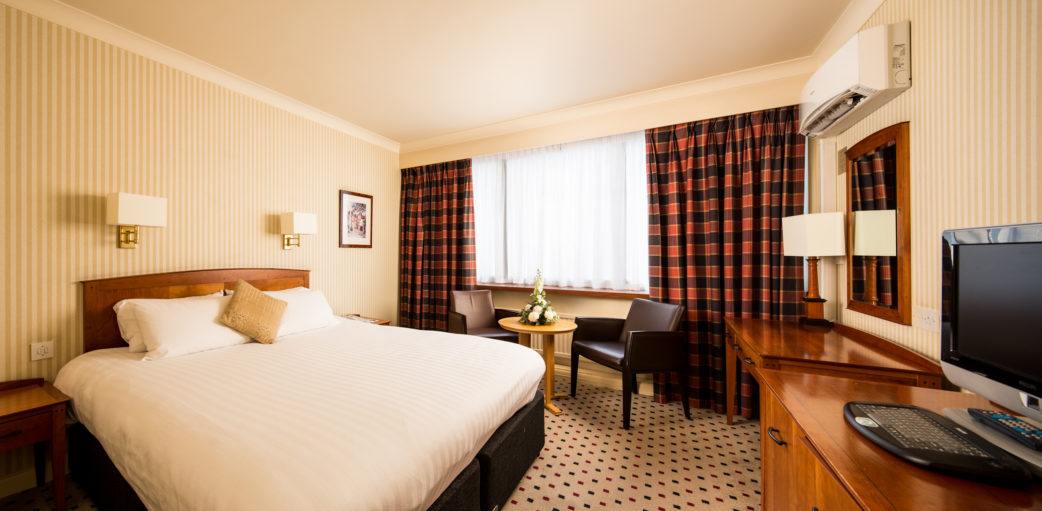 mercure-norwich-hotel-classic-double-room-01-lr-050712 Classic double bedroom at Mercure Norwich Hotel, double bed, side table and desk with TV