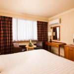 Classic double bedroom at Mercure Norwich Hotel, double bed, side table and desk with TV