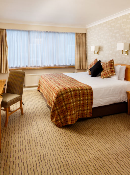 Classic family bedroom at Mercure Norwich Hotel, double bed, side table and desk with TV, sofa bed