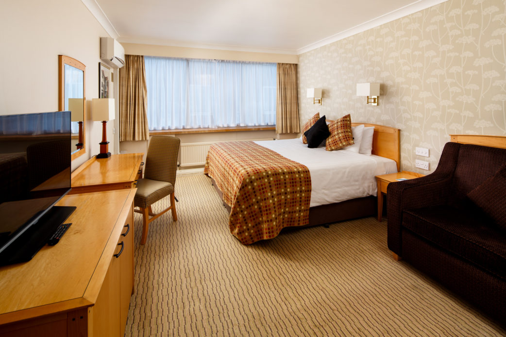 Classic family bedroom at Mercure Norwich Hotel, double bed, side table and desk with TV, sofa bed
