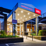 Exterior shot of Mercure Norwich Hotel, hotel entrance walkway at dusk