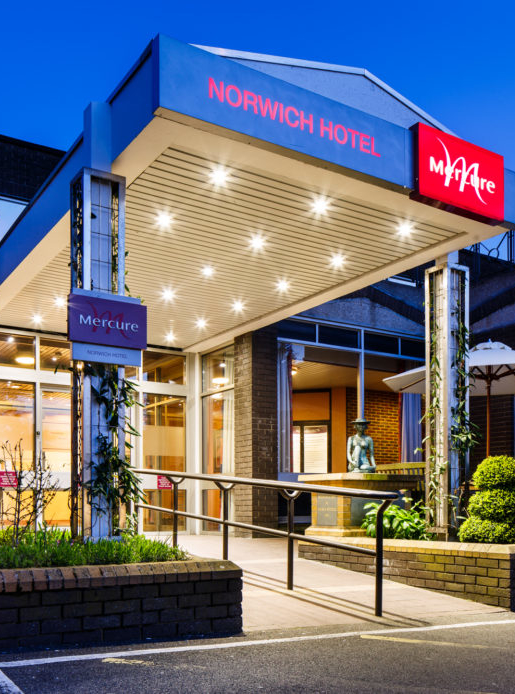 Exterior shot of Mercure Norwich Hotel, hotel entrance walkway at dusk