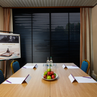 The First Avenue meeting room at Mercure Norwich Hotel, set up for a meeting, bowl of apples on the table