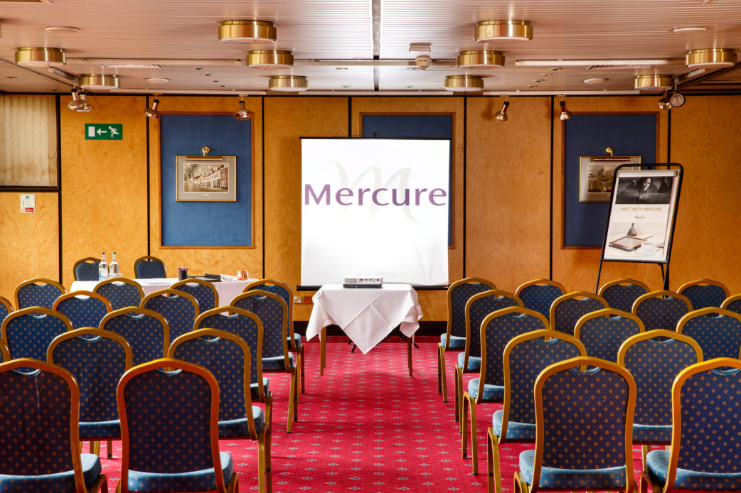 The Presidential Suite at Mercure Norwich Hotel set up for a meeting, projector, presentation board