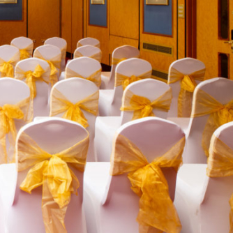 The Presidential Suite at Mercure Norwich Hotel set up for a wedding ceremony, red carpet aisle, white and yellow theme