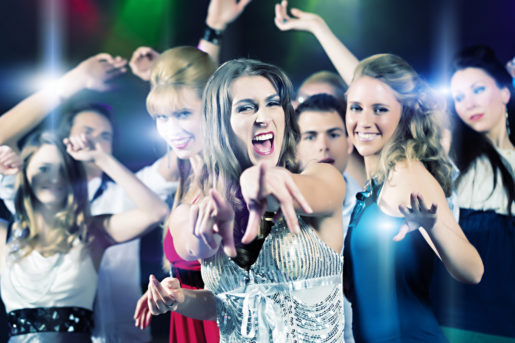 Young people dancing in club or disco party, the girls and boys, friends, having fun