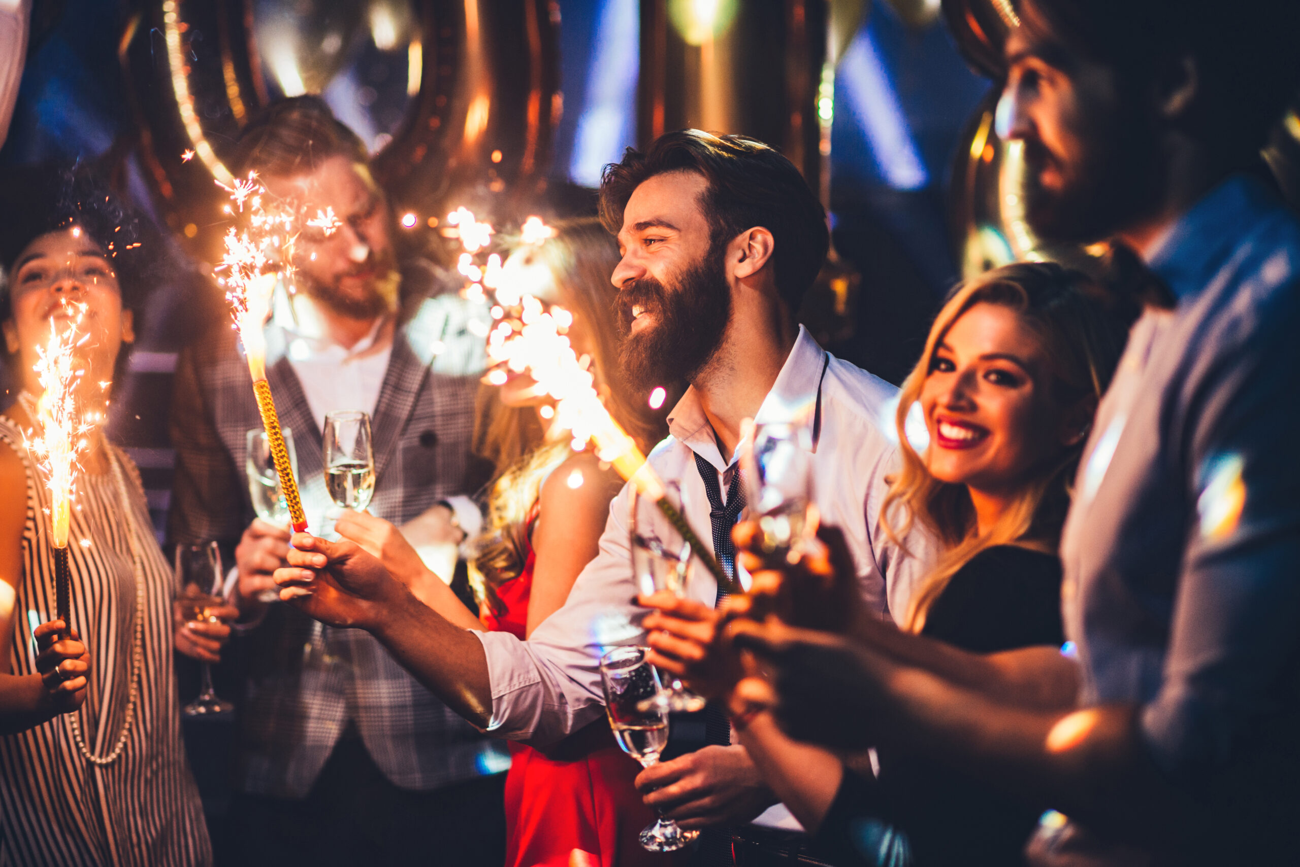 Cropped,Shot,Of,A,Young,Man,Holding,A,Sparkler People celebrating new years eve